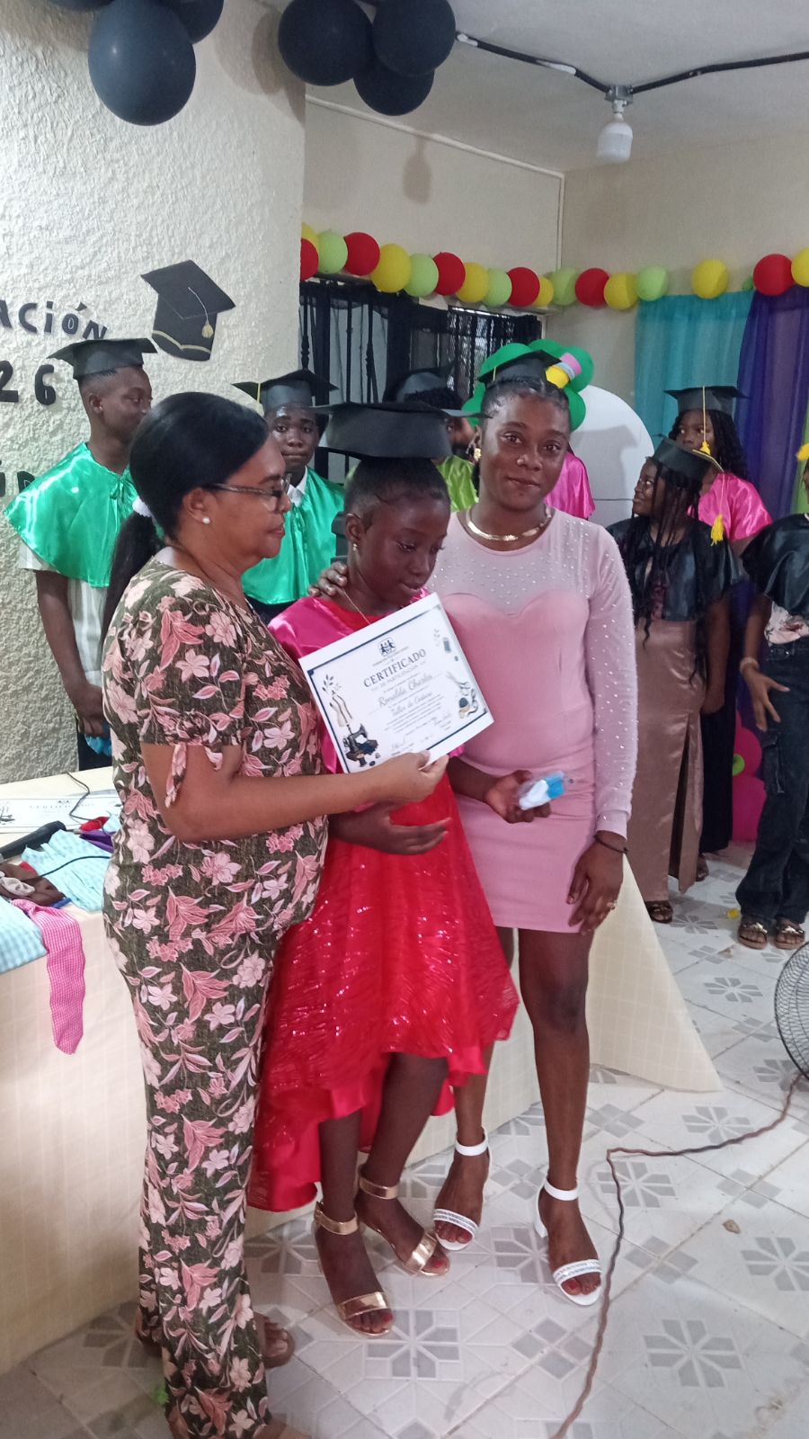 Teacher, family, and student during graduation recognition